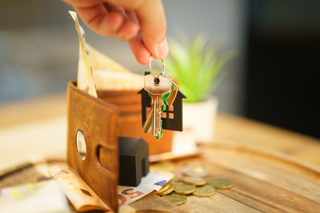 House keys, wallet and household bills representing the monthly cost of owning a home in Dunedin, Florida