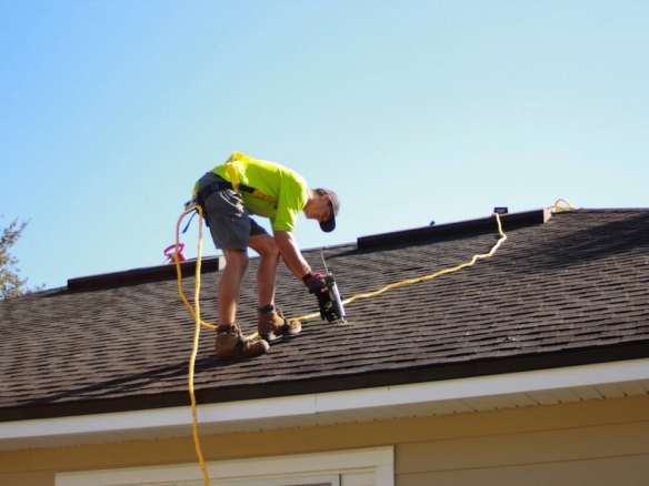 Roof professional examining a home before a Dunedin, Florida real estate purchase