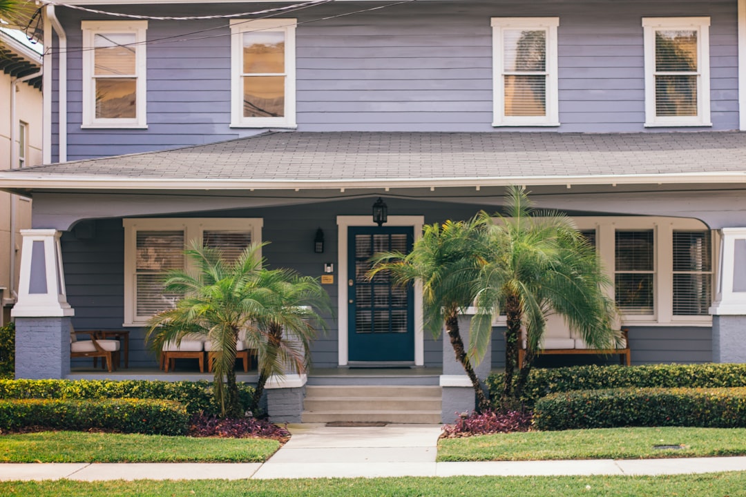 Blue Florida home with palm trees showing curb appeal before selling a house in Dunedin